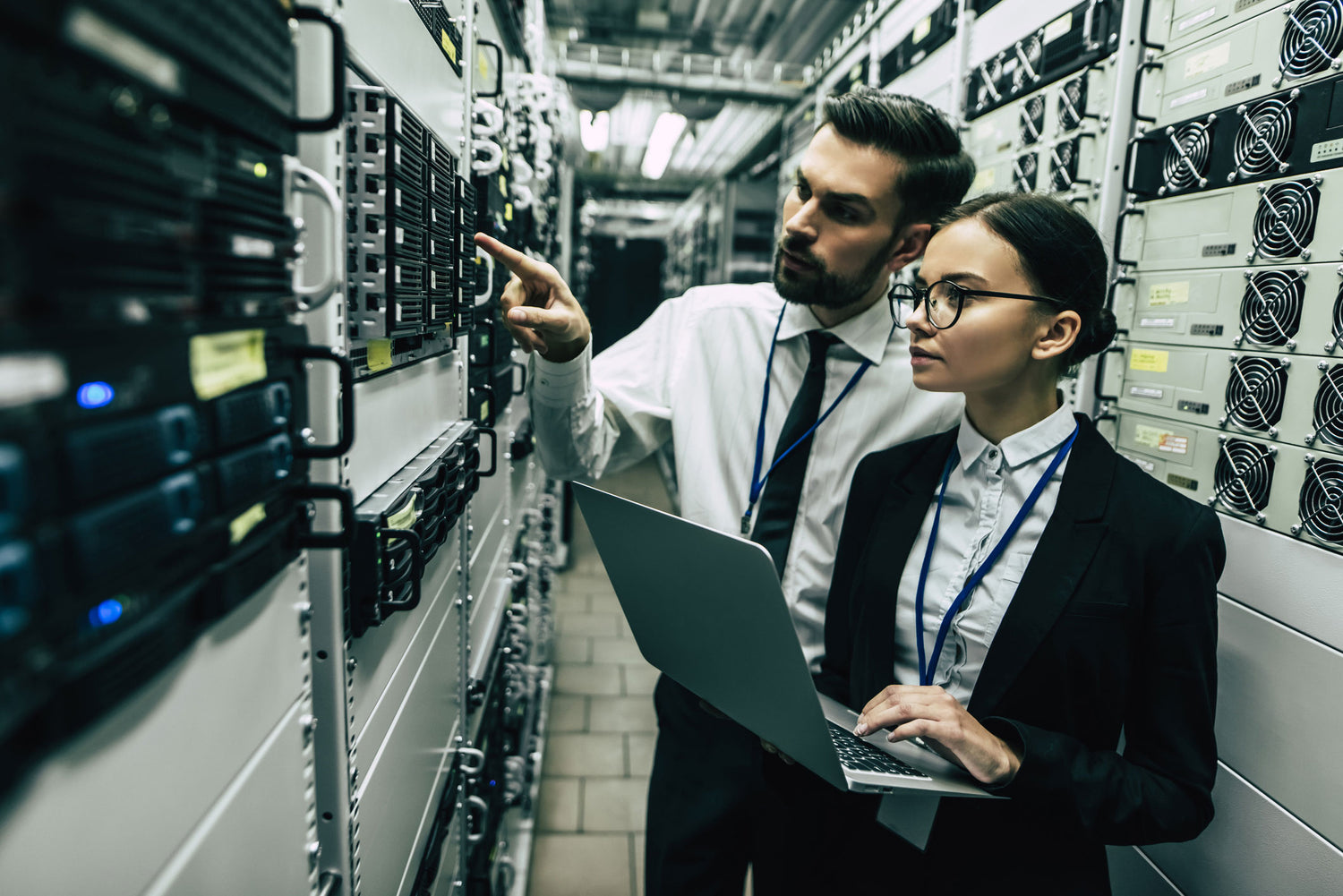 Two IT workers in server room